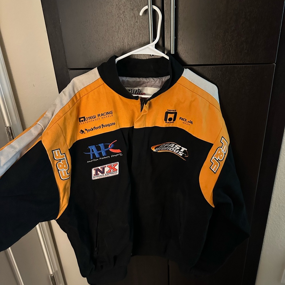 Black and Orange Racing Jacket with Durable Weather-Resistant Material
